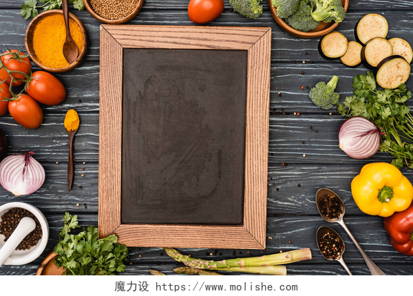 桌子上的相框和蔬菜色彩艳丽的新鲜蔬菜和木制桌子上的空黑板的顶部视图